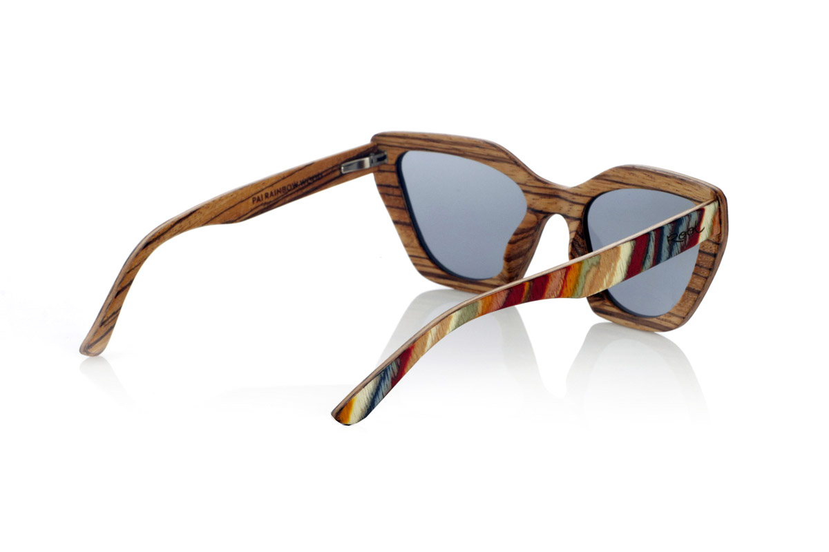 Wood eyewear of Zebrano PAI. PAI wooden sunglasses are made from laminated skateboard wood, with a multi-coloured finish that highlights their distinctive design. Their layered structure highlights natural textures, combining a striking front with a zebrawood interior that provides an elegant contrast.

The butterfly-shaped design offers a bold and original silhouette, balancing style and comfort. Thanks to their laminated wood construction, they are resistant and light, ideal for daily use.

The high-quality polarised lenses fully protect against UV rays and reduce glare, providing a clearer and more comfortable vision. A different proposal within the wooden glasses collection, connecting design and natural materials.

Dimensions 144x50 mm. Caliber 53 for Wholesale & Retail | Root Sunglasses® 