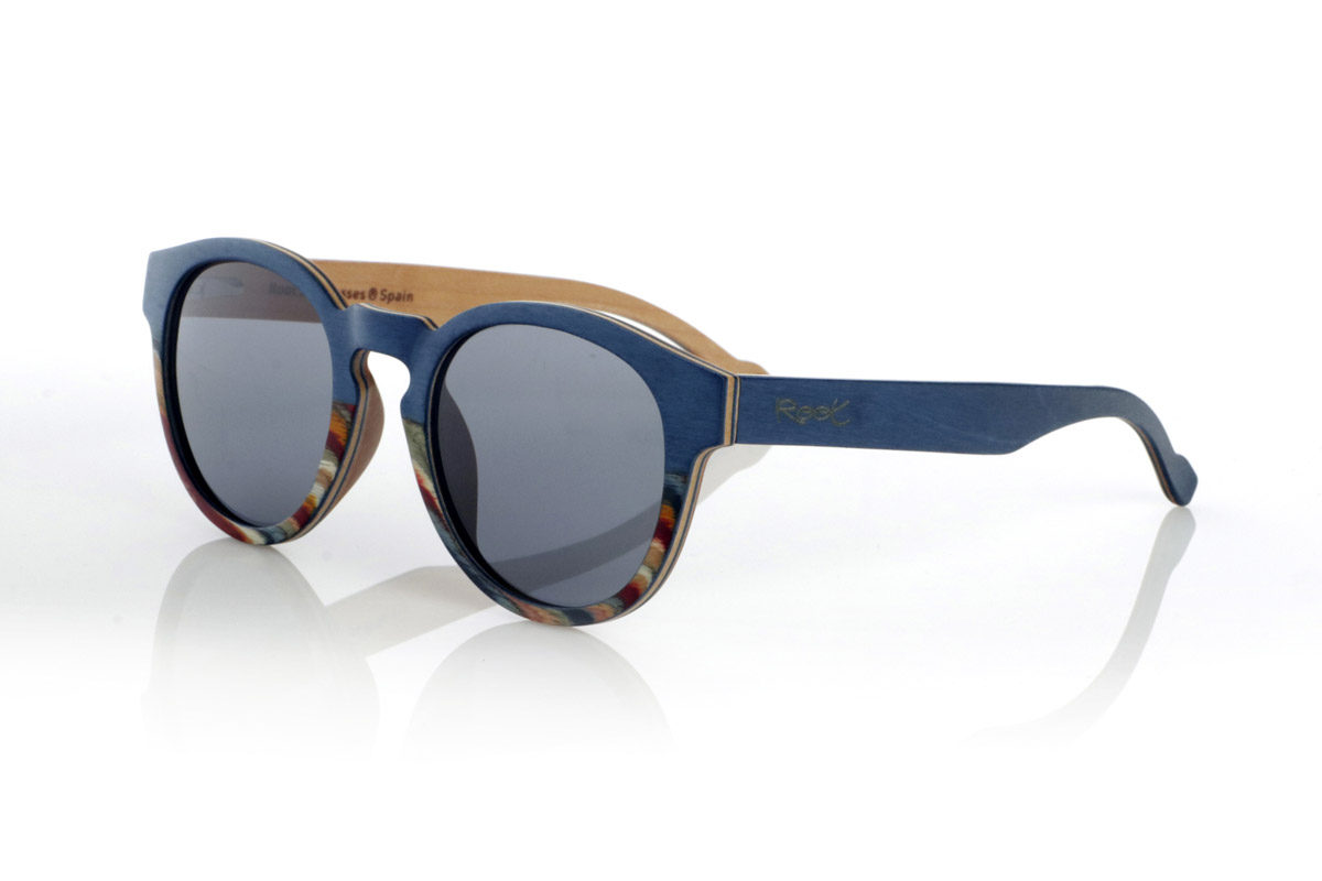 Wood eyewear of Maple WANZ. WANZ sunglasses are made from a combination of laminated woods that provide a unique and distinctive style. Its blue maple wood front merges with a multicoloured rainbow skateboard sheet, creating a dynamic and original visual effect. The temples, made from blue tinted maple with a natural maple wood interior, complement the design with a balance between modernity and warmth.

Thanks to their layered wood construction, these wooden sunglasses guarantee strength without compromising comfort. They incorporate high-quality polarised lenses that offer full UV protection and reduce glare, improving visual clarity.

A versatile model that stands out for its bold design and its inspiration from nature. Dimensions: 138x52mm. Caliber 49. for Wholesale & Retail | Root Sunglasses® 