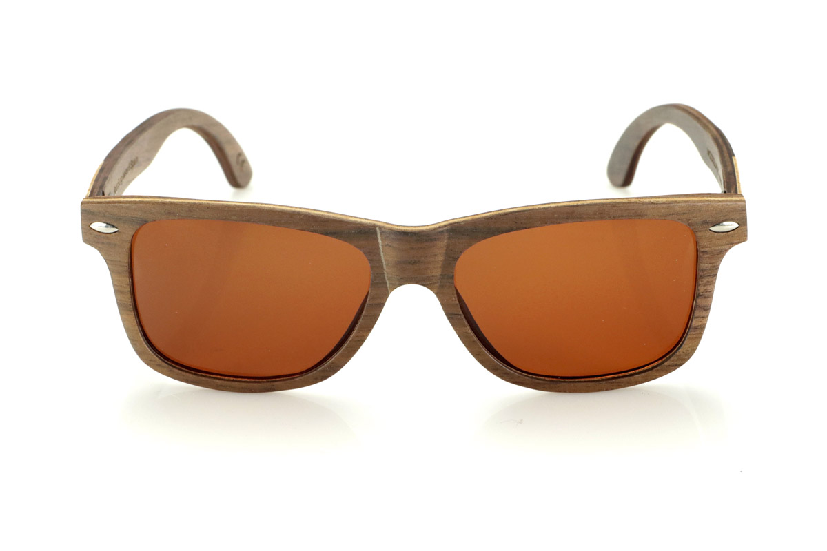 Wood eyewear of Walnut WOODSUNSET SK. The Woodsunset wooden sunglasses are made from black walnut wood, offering an elegant and timeless design with a natural finish. Its laminated structure includes a natural maple interlayer, providing a subtle contrast that enhances its sophistication.

The temples feature a unique detail with a combination of walnut and oak, giving this model a distinctive touch. In addition, the front features small metal ornaments, which not only reinforce the structure, but also add a vintage feel to its design.

Thanks to its classic and versatile shape, the Woodsunset are an excellent choice for both men and women looking for wooden glasses with character and style.

Measurements: 147x47 Caliber: 49 for Wholesale & Retail | Root Sunglasses® 